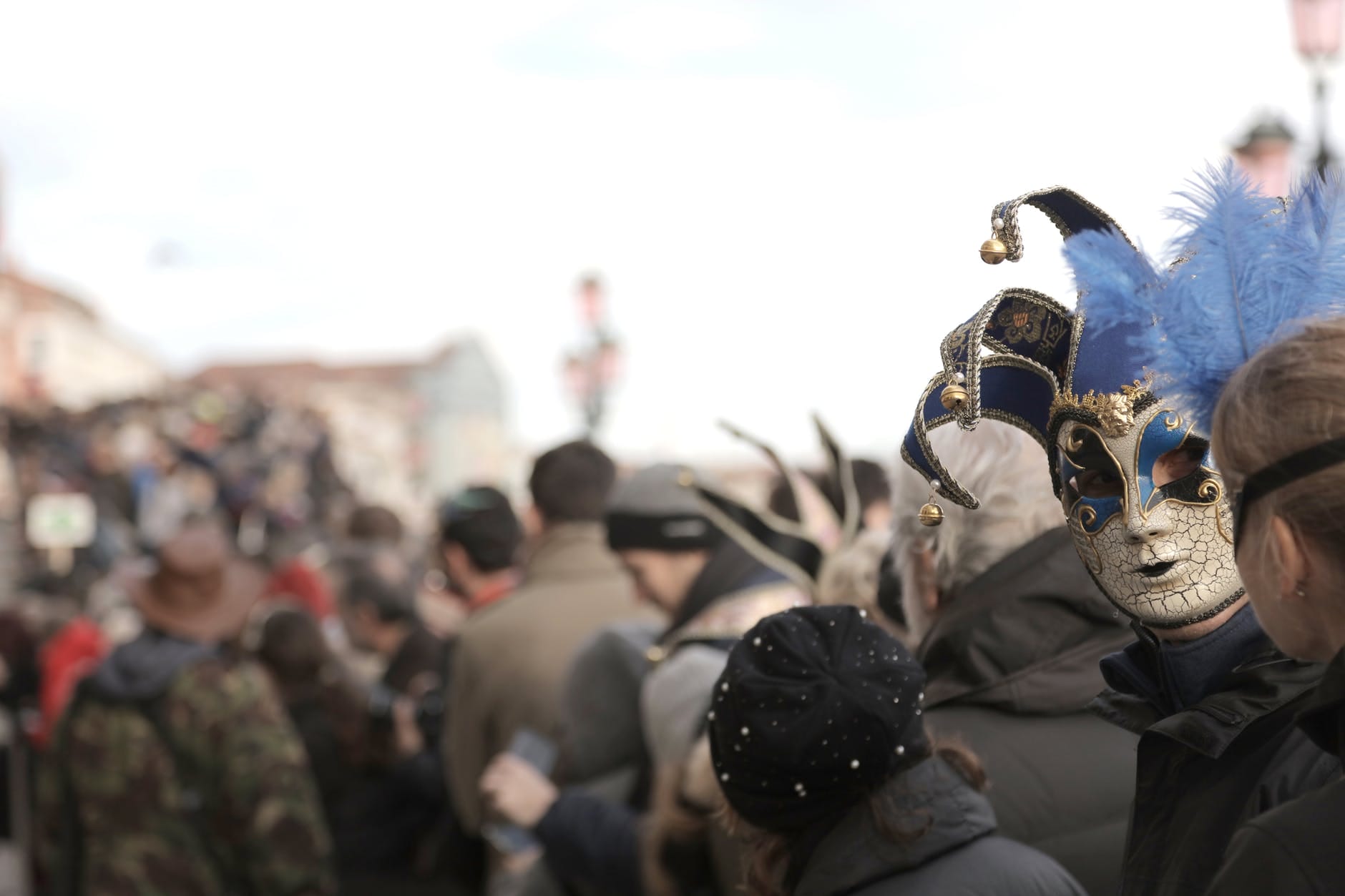 person in jester mask in city