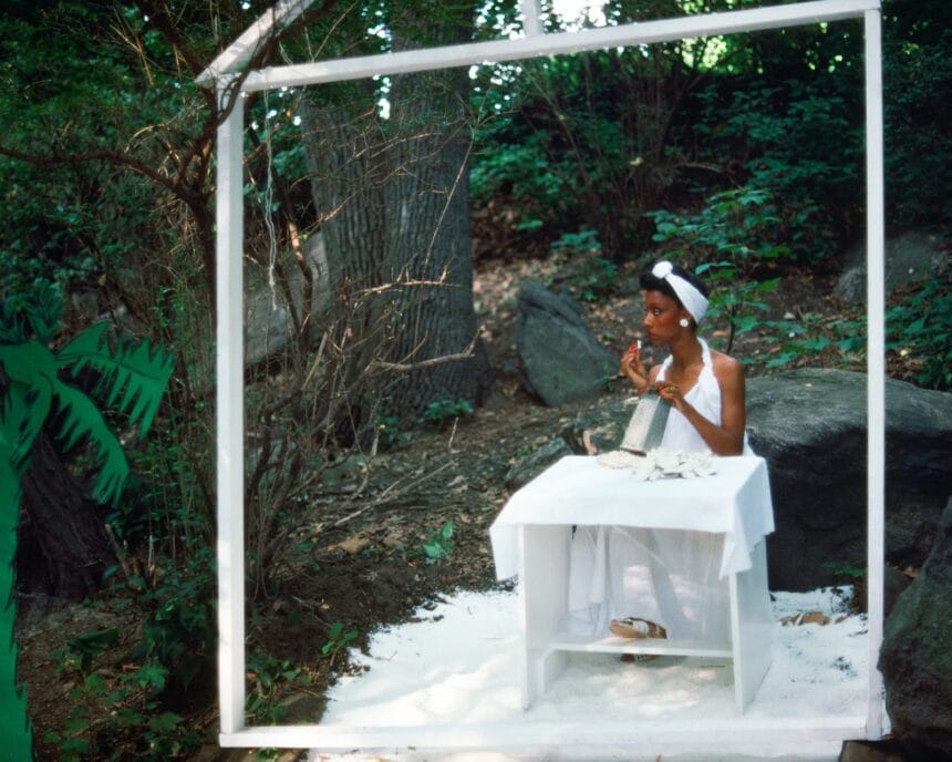 Lorraine O'Grady, Rivers, First Draft: The Woman in White eats coconut and looks away from the action, 1982/2015, digital C-print from Kodachrome 35mm slides in 48 parts, 16 x 20 in (40.64 x 50.8 cm), edition of 8 plus 2 AP