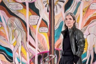 Emma Talbot, portrait in the artist's studio, pictured with When Screens Break, (2020). Photo by Thierry Bal.